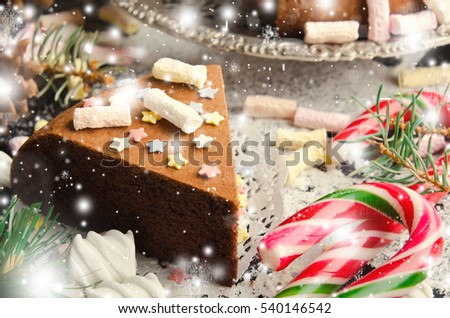 Traditional Homemade chocolate Christmas cake with sugar stars and marshmallow, new year decoration with snow, toned