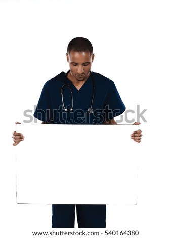 Male surgeon doctor in scrubs holding up a blank sign isolated on white background 