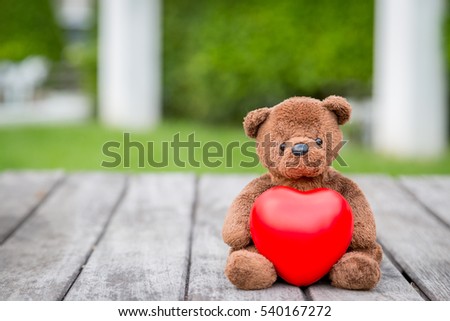 Brown Bear and Red Heart with old wood background for take care your love