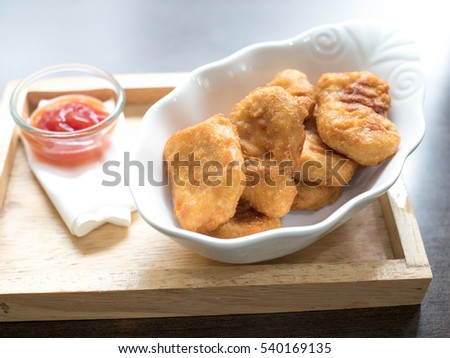 chicken nugget and delicious menu on beautiful plate in a restaurant.