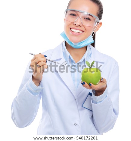 Smiling woman doctor with a green apple