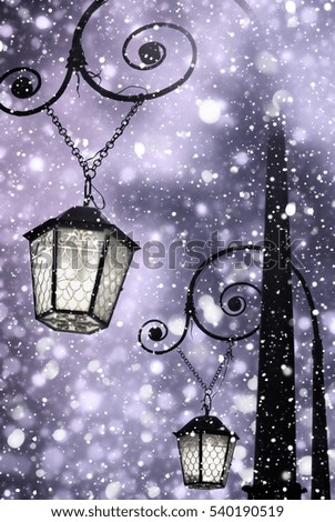 Christmas background. Vintage street lamp with light among shine snow. Christmas landscape