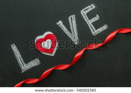 Love text written on chalkboard. Valentine's Day Concept