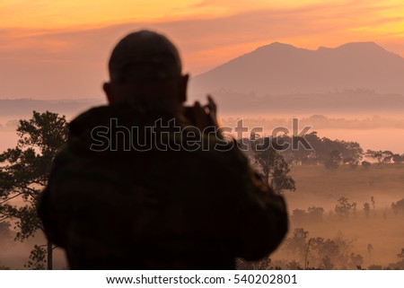Silhouette of photographers in Sunrise, selective focus