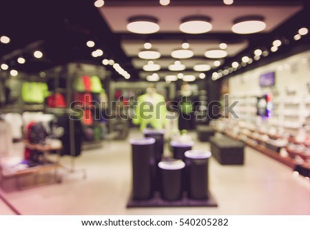 Abstract blurred photo of fashion store in shopping mall which have clothing bag and shoes, shopping concept