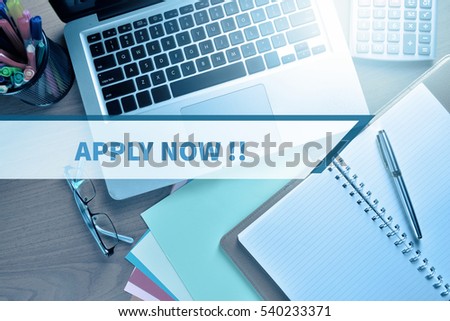 Notebook and Laptop with graph and charts with word APPLY NOW