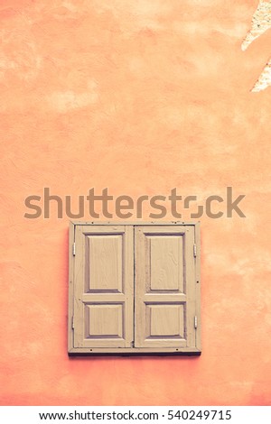 Window on orange cement wall - retro vintage filter effect
