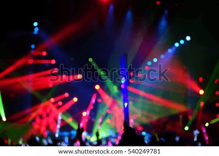 Defocused entertainment concert lighting on stage, blurred disco party.
