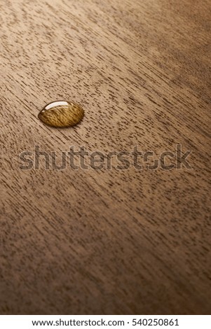 Water droplets on a wooden surface