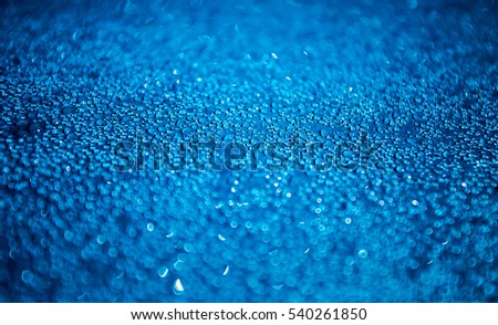 Dew drop on blue canvas and blur background