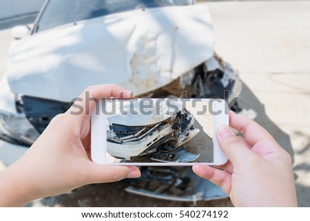 Female using mobile smart phone taking photo of the car crash accident damage for insurance