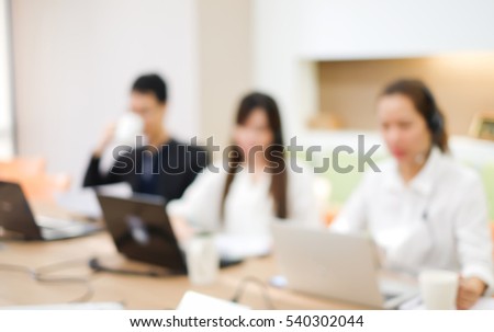 abstract blurred group of asian employee work as call center in office room Royalty-Free Stock Photo #540302044