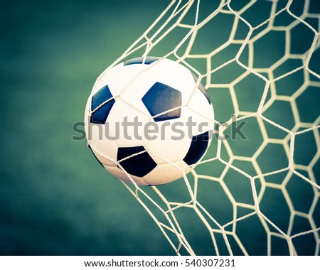 soccer ball in goal net - retro vintage filter effect Royalty-Free Stock Photo #540307231