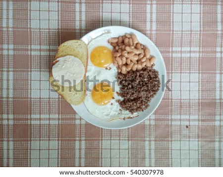 Scrambled eggs, sandwich, haricot, buckwheat. Stock photo