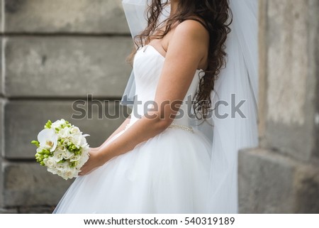 Beautiful bride with bouquet before wedding ceremony