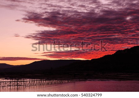 sunrise over river and mountain with colorful sky background.