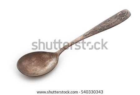 Very old rusty vintage silver spoon isolated on a white background, close up.