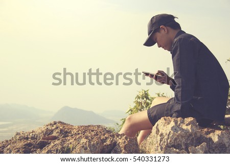 tourist traveler on background panoramic view of the mountain. Mock up for text message. Male hands using smartphone