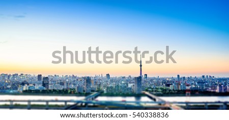 Business concept for real estate corporate - panoramic modern city skyline bird eye aerial night view under dramatic glow and beautiful dark blue sky in Tokyo, Japan. Miniature Tilt-shift effect