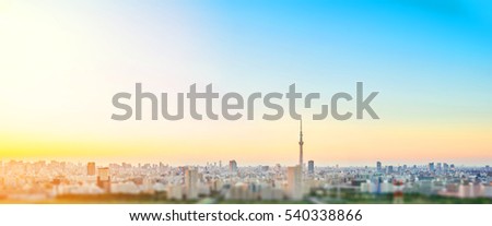 Business and culture concept - panoramic modern city skyline bird eye aerial view under dramatic sunset glow and beautiful cloudy sky in Tokyo, Japan. Miniature Tilt-shift effect