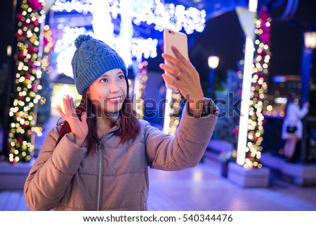 Woman using mobile phone to take photo