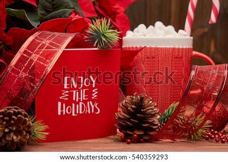 Christmas decoration with Red Poinsettia flowers (Euphorbia Pulcherrima), fir branch and mug with cocoa and marshmallows on wooden background.  New year and Christmas background with copy space.