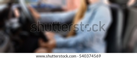 Blond woman driving car theme creative abstract blur background with bokeh effect