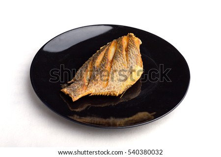 fish fry on black plate  ,Tilapia Fish,planil, thai food.
