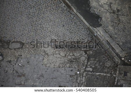 Top angle View of Monotone Grunge Cracked Gray Brick Marble Stone on The Ground for Street Road. Sidewalk, Driveway, Pavers, Pavement in Vintage Design Flooring Square Pattern Texture Background