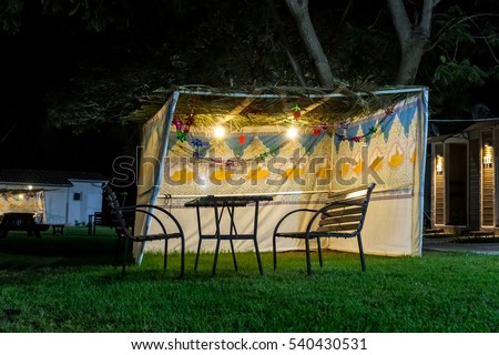 Fabric sukkah decorated with printed pattern and hebrew text of blessing: Grant peace everywhere goodness and blessing, Grace, loving kindness and mercy to us and unto all Israel, Your people. Night