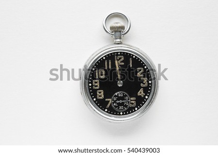 An old fob watch showing just before 12oclock