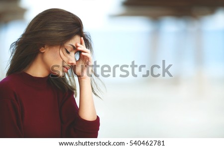 Stressed Woman with Headache on the Beach. Outdoor Sad Woman Royalty-Free Stock Photo #540462781