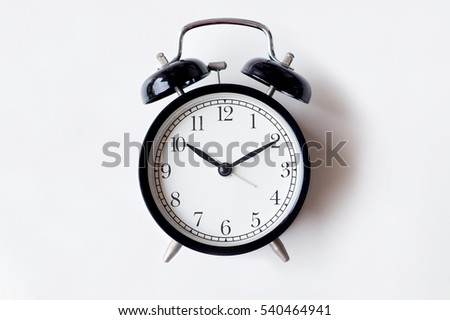 Black alarm clock isolated on white
