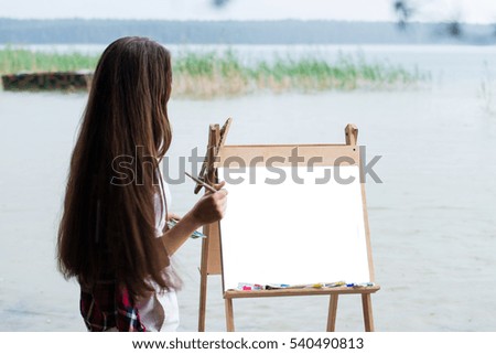 painter draws a picture on an easel, mocup, copy for text