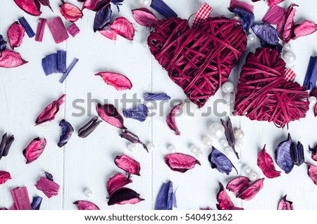 Two clews in shape of heart on white wooden background
