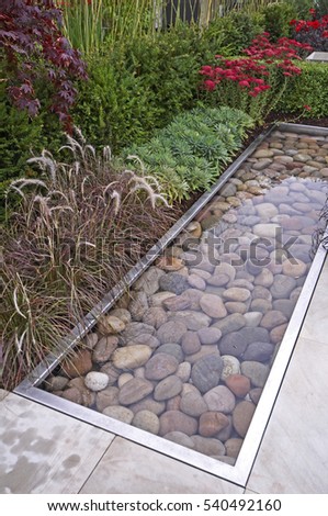 The contemporary patio area and water feature in a Relax and Reflective garden