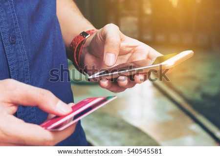 Man use smart phone and holding credit card with shopping online. Online payment concept. Royalty-Free Stock Photo #540545581