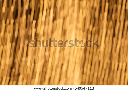 abstract background of golden bokeh of lamp in party with technic out of focus and moving camera.