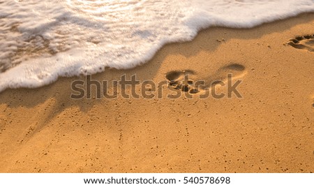 Bubbles waves and foot print on the beach  background.