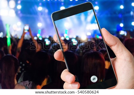 people use smart phones record video at music concert 
