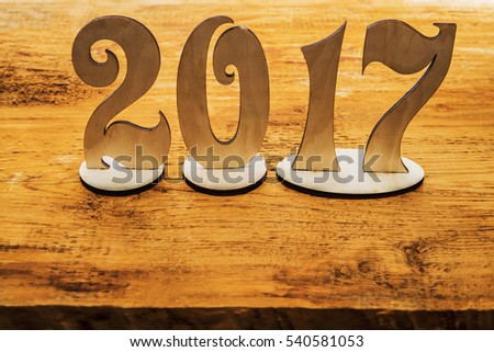happy new Year 2017 - wooden digits lie on wooden plank background. photo image. empty copy space for inscription or other objects. happy new year 2017 background