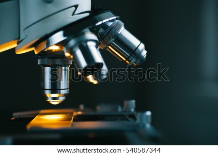 Close up of examining of test sample under the microscope in laboratory. Royalty-Free Stock Photo #540587344