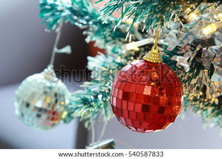 Christmas tree background with baubles and glass balls. Bright Christmas balls and garland with lights. Christmas Holiday concept.