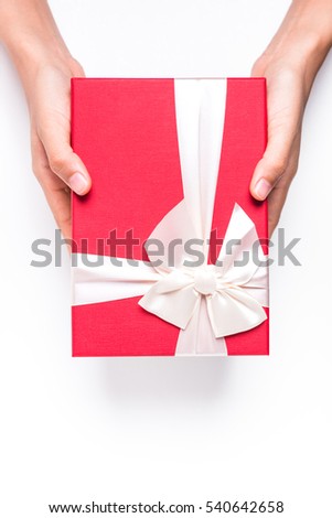 Female hands holding gift box on white background. 