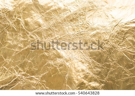 Gold wrinkled paper texture abstract background Royalty-Free Stock Photo #540643828