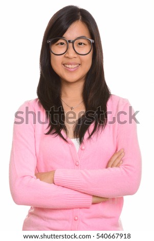 Young happy Asian nerd woman smiling isolated against white background