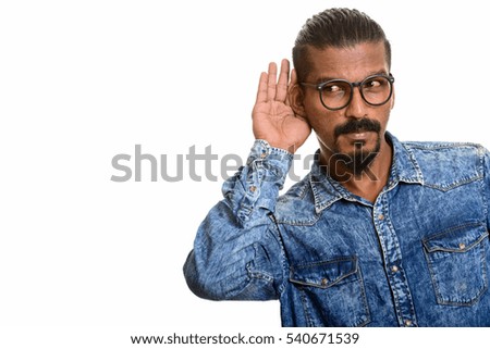 Young Indian man listening isolated against white background
