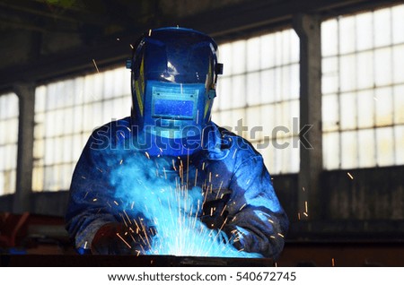Welders working at the factory made metal