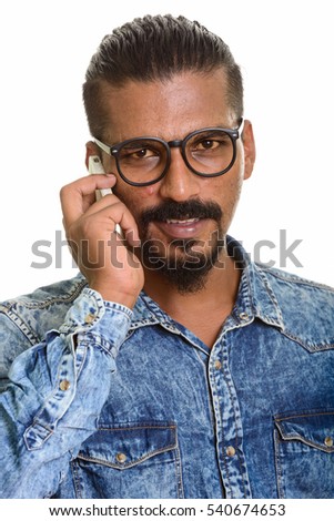 Young Indian man talking on mobile phone isolated against white background