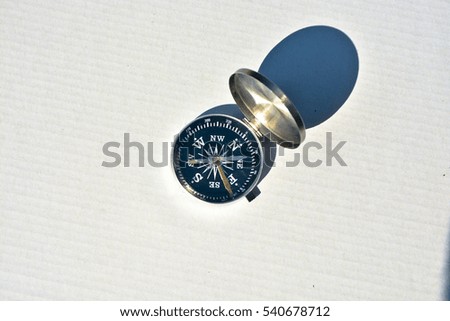 Compass on white. Magnetic navigation tool for orienteering.